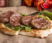 Ege Köfte Alanya restoranında servis edilen ızgara köfte tabağı ve yanında sunulan mezeler