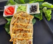 Alanya’daki Demet Cafe Kahvaltı ve Gözleme’nin doğal bahçe ortamı ve el açması gözleme sunumu