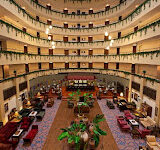 Royal Garden Select Suite Hotel’in denize sıfır konumdaki havuzu, lüks otel binası ve Akdeniz manzarasıyla birlikte güneşli bir yaz gününde görüntülenmiş