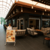 Menü tabelası önünde duran müşteri ile Cafe Life’ın geniş tente altındaki konforlu kafe alanı.