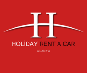 Holiday Rent A Car ofisinde park etmiş kiralık araçlar, ön planda sedan ve SUV modelleri