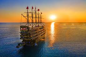Alanya boat tours cruising against a stunning sunset with 2026 campaign offers