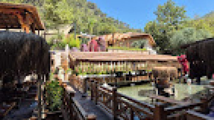 Dimçayı Soğuk Göl Restaurant’ta nehir kenarında masa düzeni, doğa manzarası ve yemek servis edilen ortam.